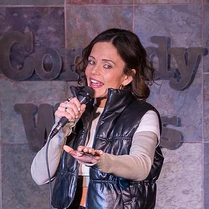 Comedian Rebecca Trejo performing standup comedy on a stage
